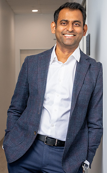 Dr Sid Kothari wearing a blue suit