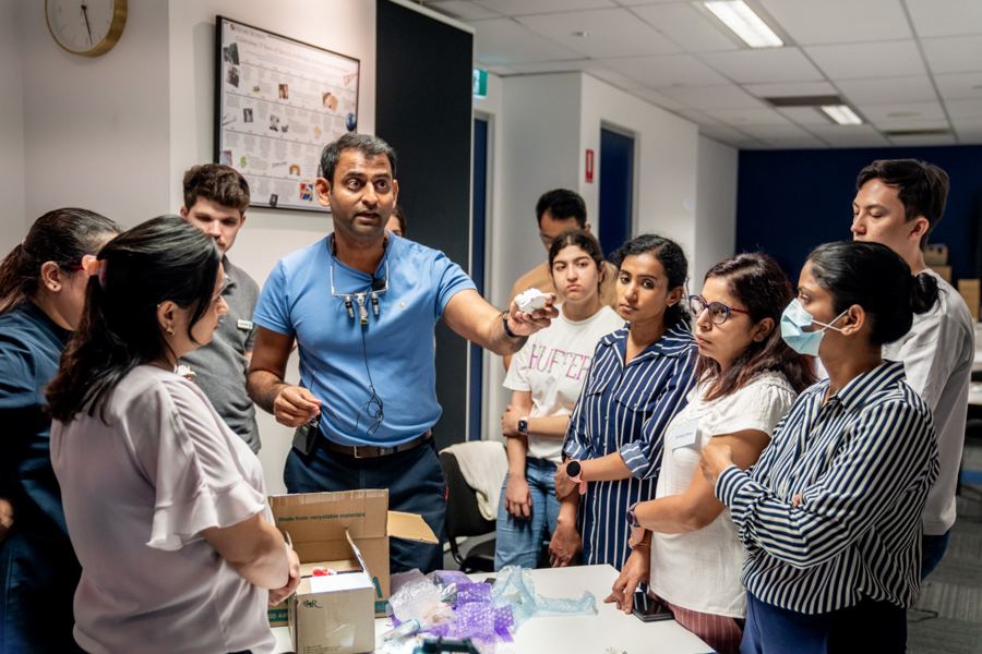 Dr Sid helping dentists practise a technique
